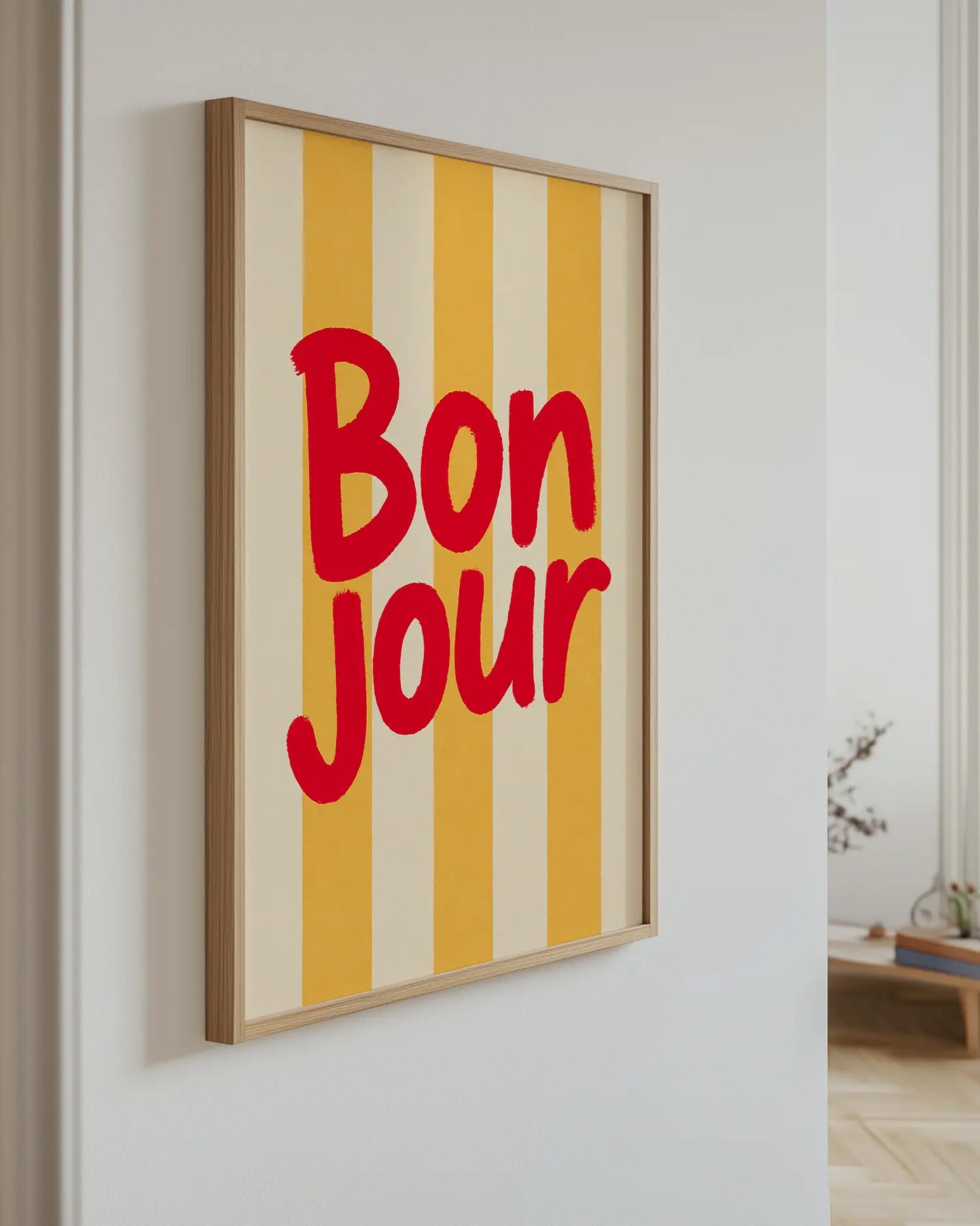 Framed artwork with 'Bonjour' text on a yellow and beige striped background
