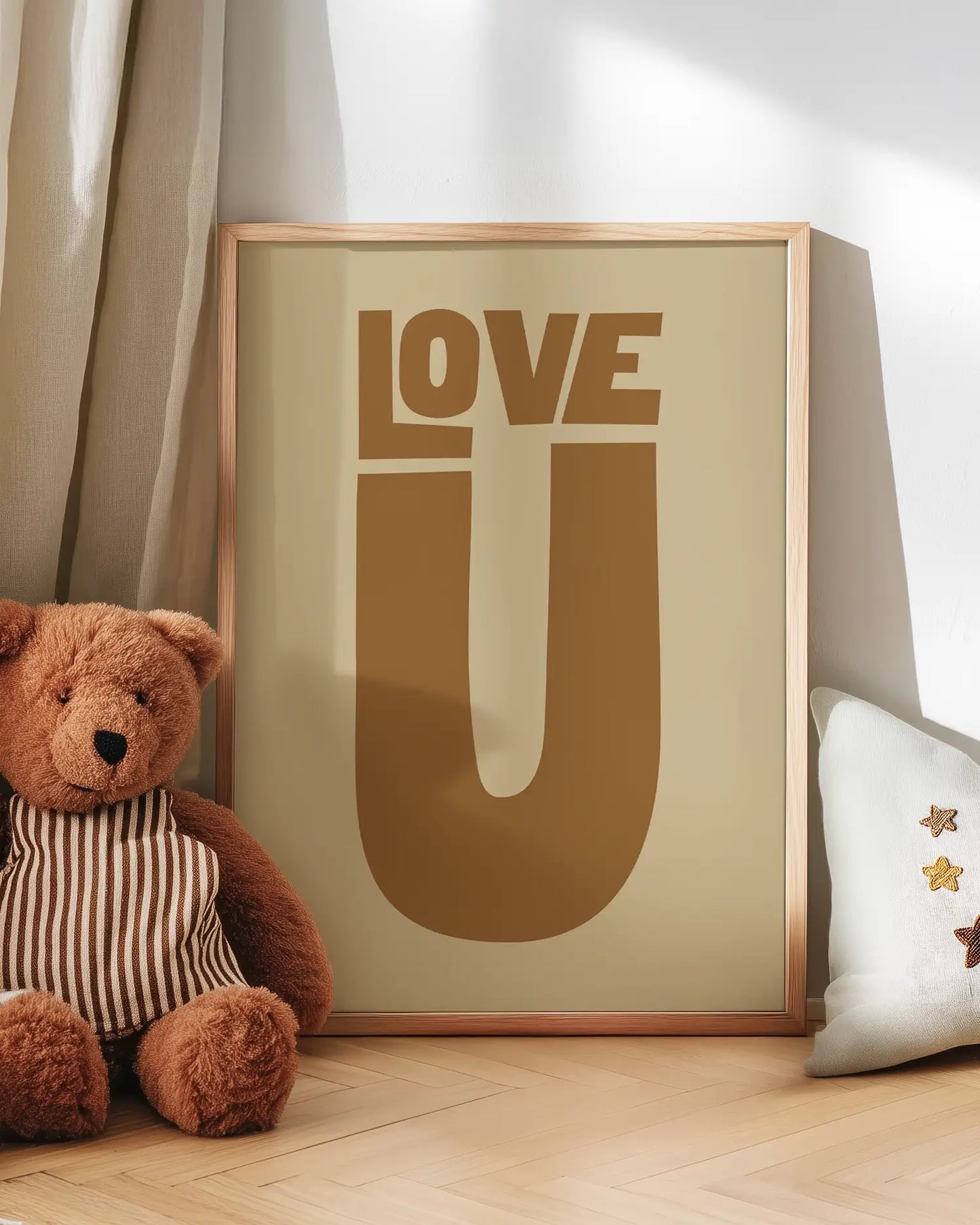 Framed artwork with 'LOVE U' text next to a teddy bear on a wooden floor.