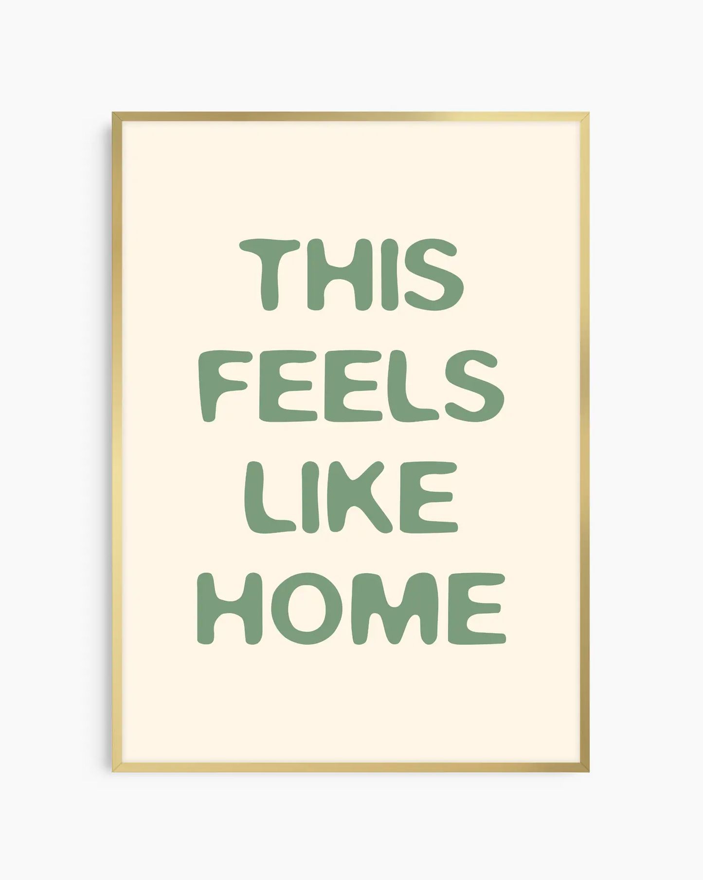 Nursery poster with the text 'This feels like home' written in green, inserted in an gold frame