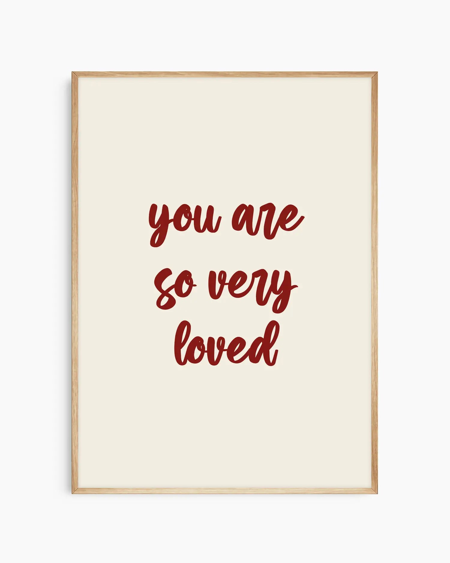 Nursery poster with red 'you are so very loved' text on a beige background. Oak frame.