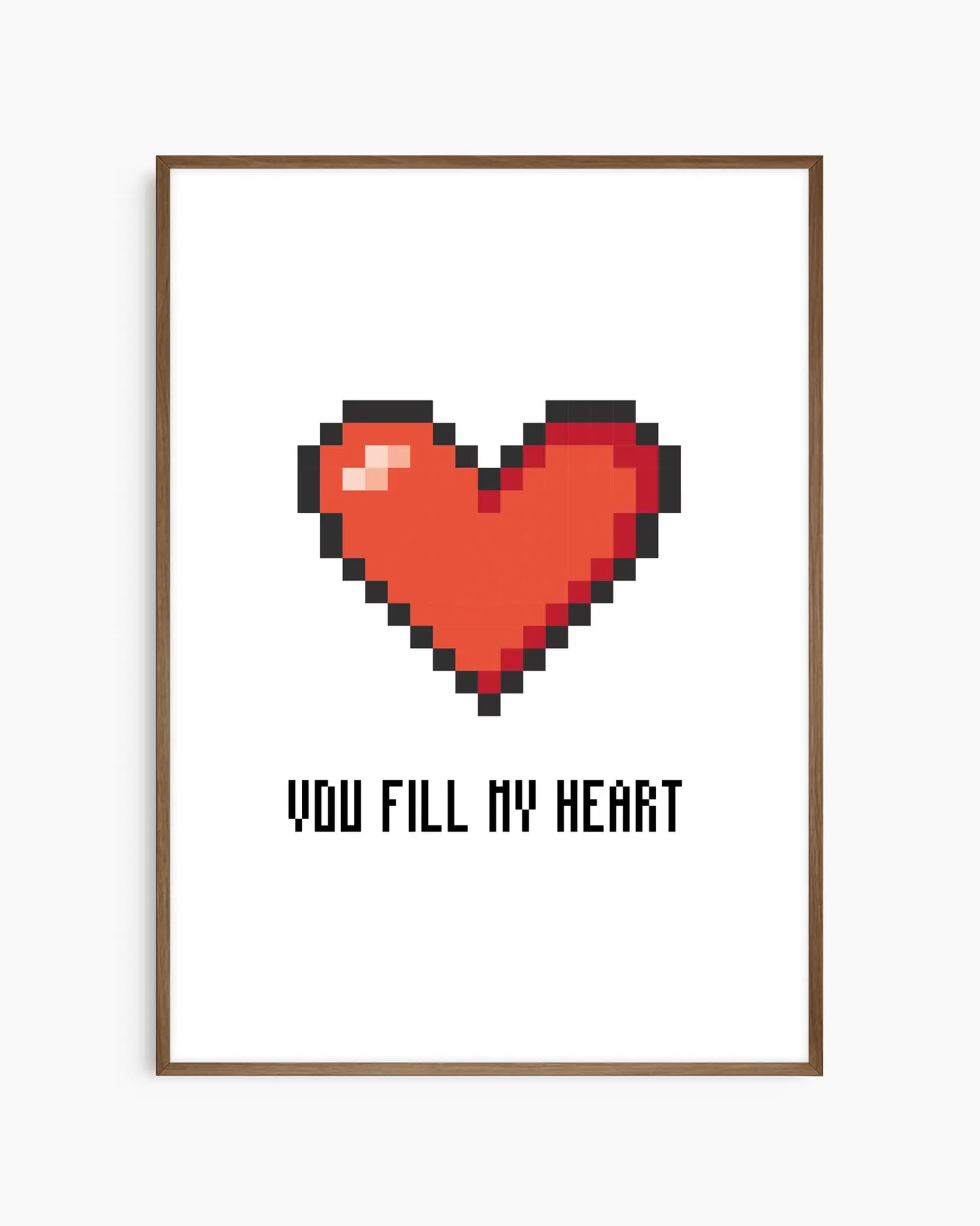 Nursery poster with a red pixel heart and the text 'You Fill My Heart' text on a white background, framed in a dark oak wooden frame.