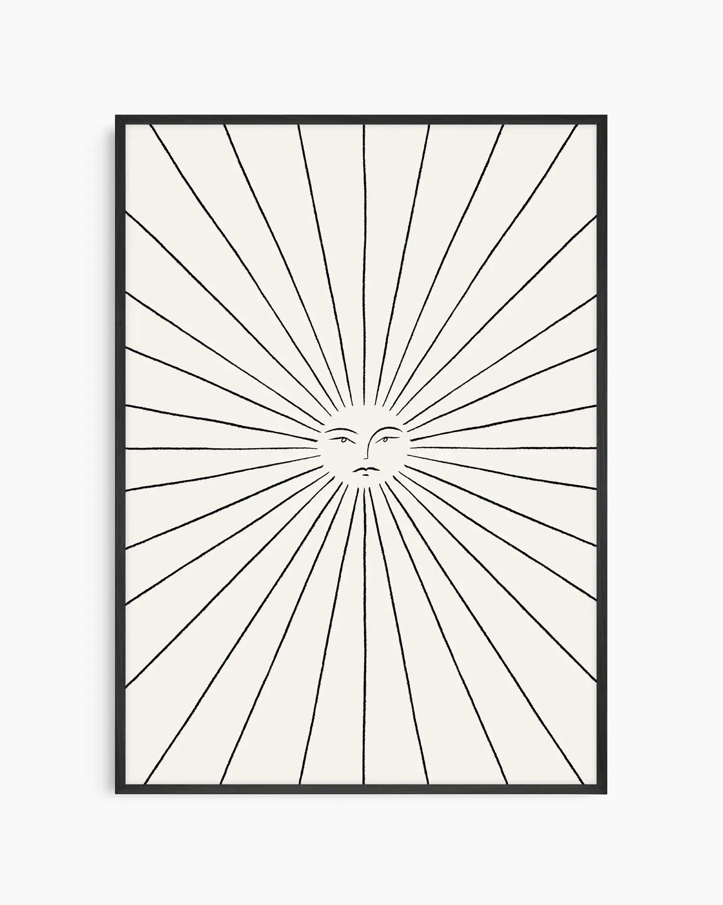 Framed artwork with a sunburst design and face in the center on a white background