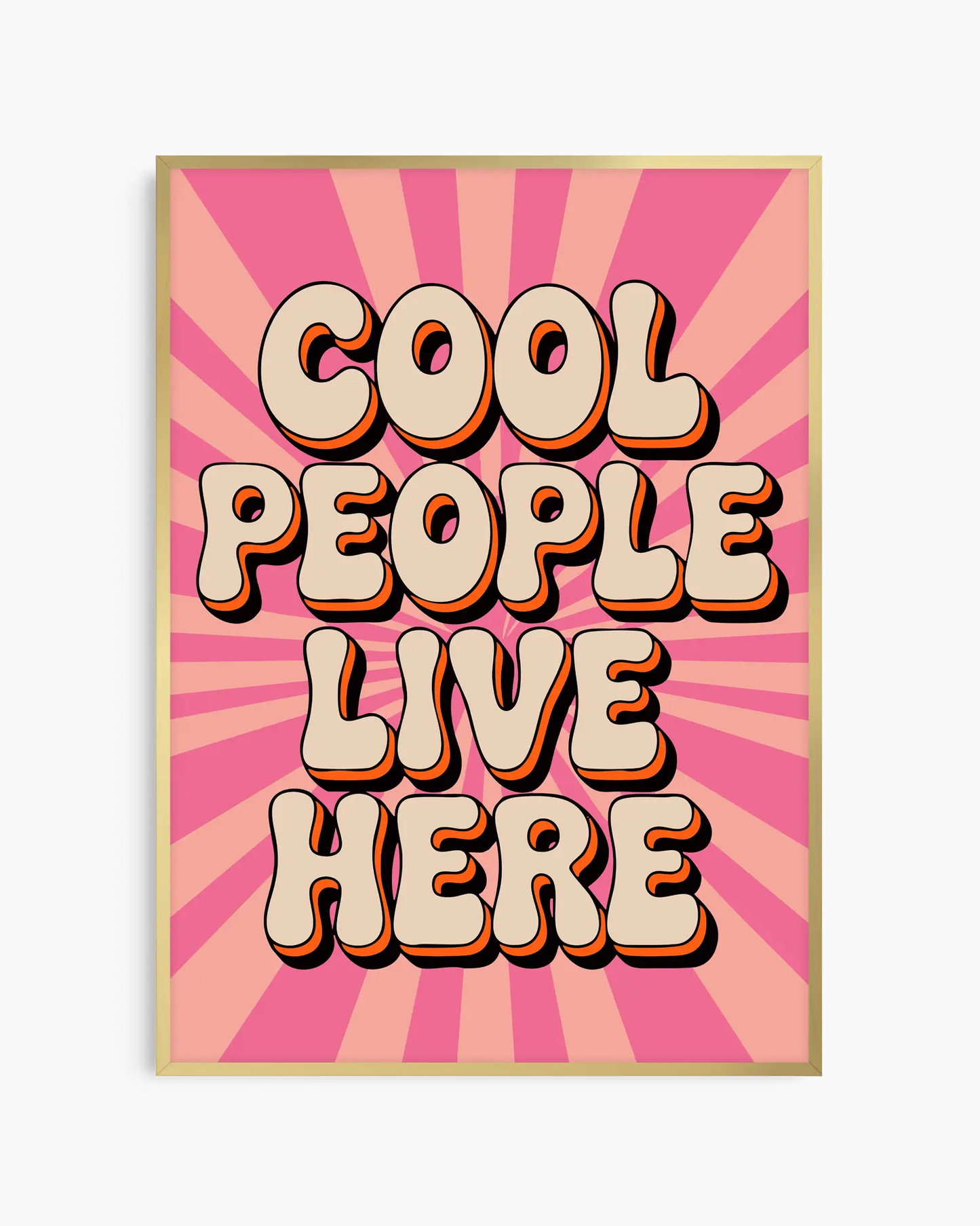 Nursery poster with 'Cool People Live Here' text on a pink sunburst background framed in a golden aluminium frame.