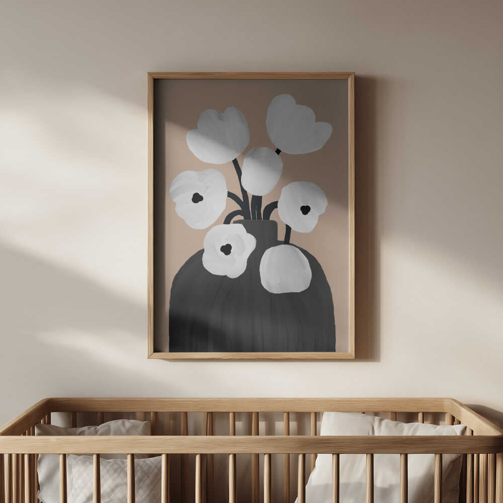 Neutral floral art print in beige, black, and white tones, framed in light wood and hanging above a baby’s crib. A minimalist botanical poster that creates a peaceful and elegant atmosphere in a modern nursery.