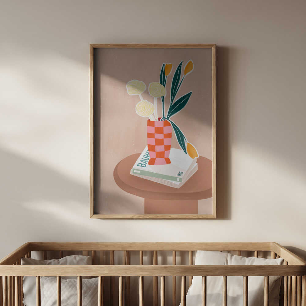 Beige poster with a brown side table with books on top and a pink and orange checkered vase with yellow flowers inside hanging in the nursery