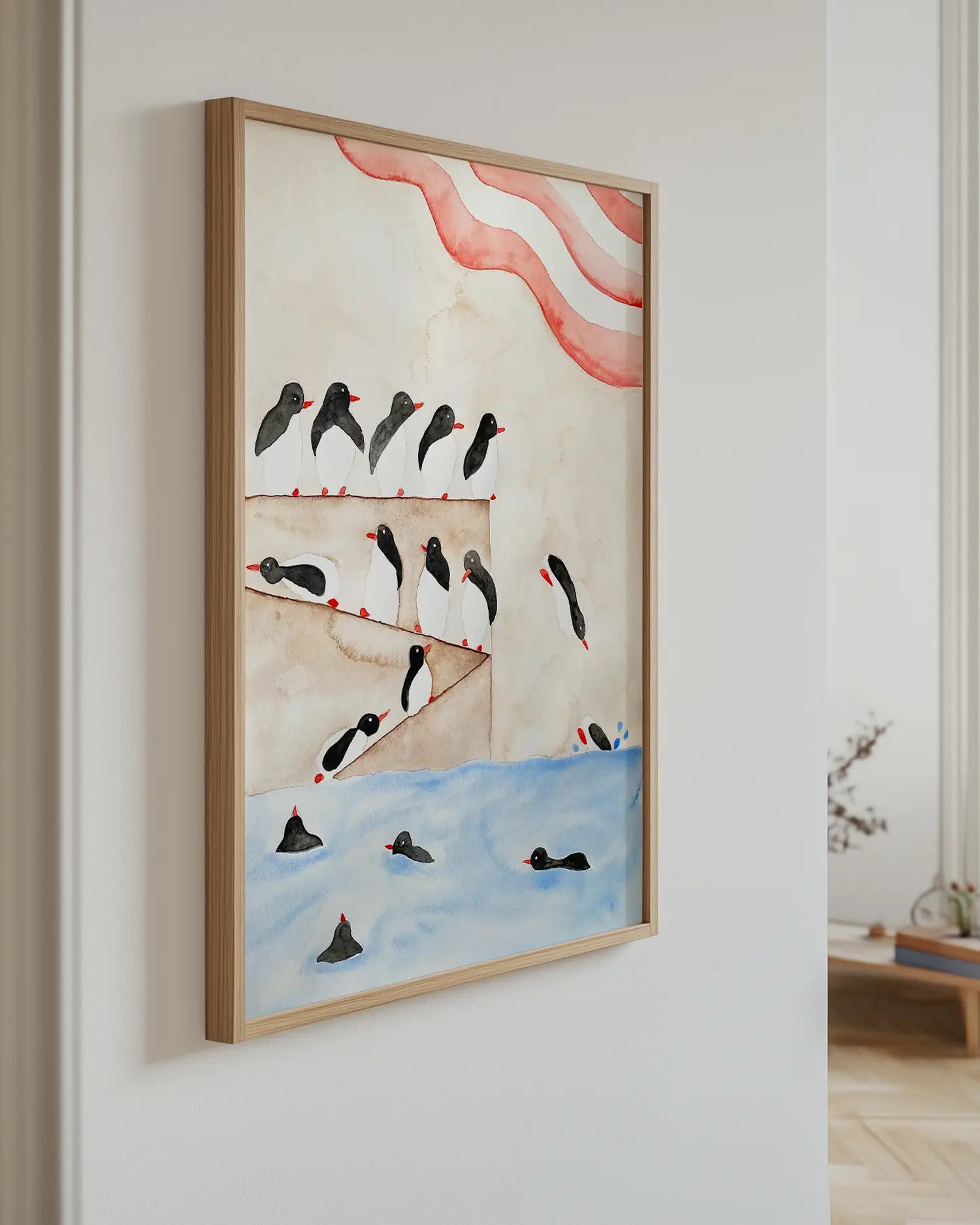 Framed artwork of penguins on a wall