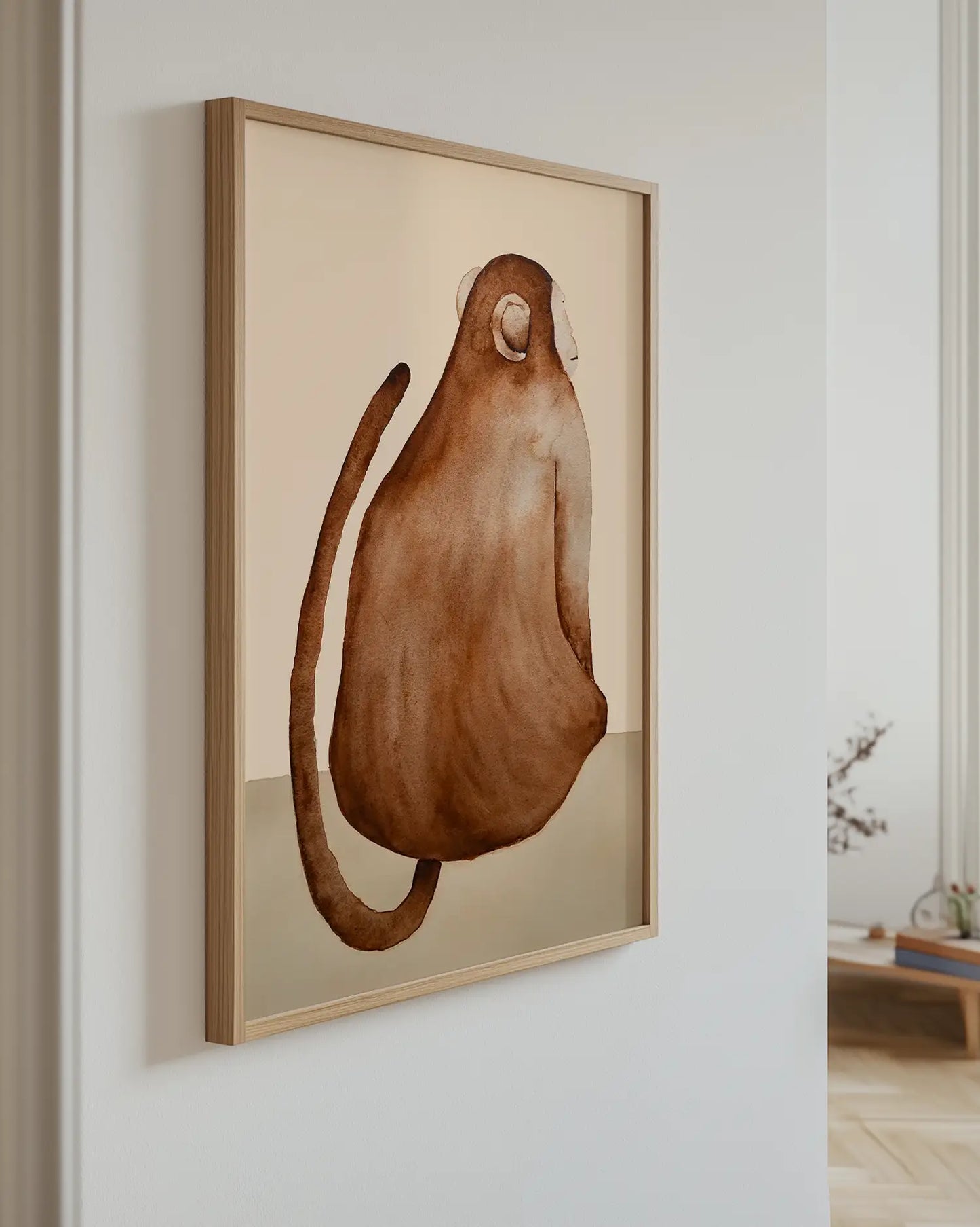 Framed artwork of a brown monkey on a beige background