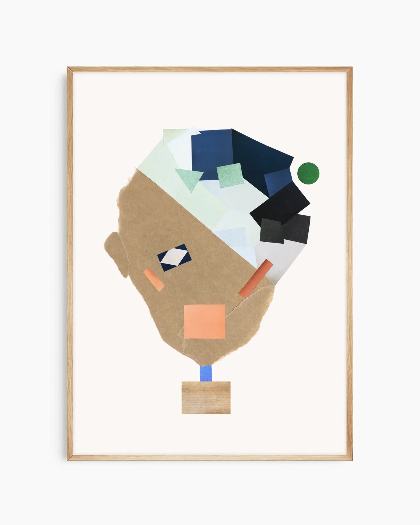 Nursery poster of a collage face made from colorful shapes on a white background framed in an oak frame.