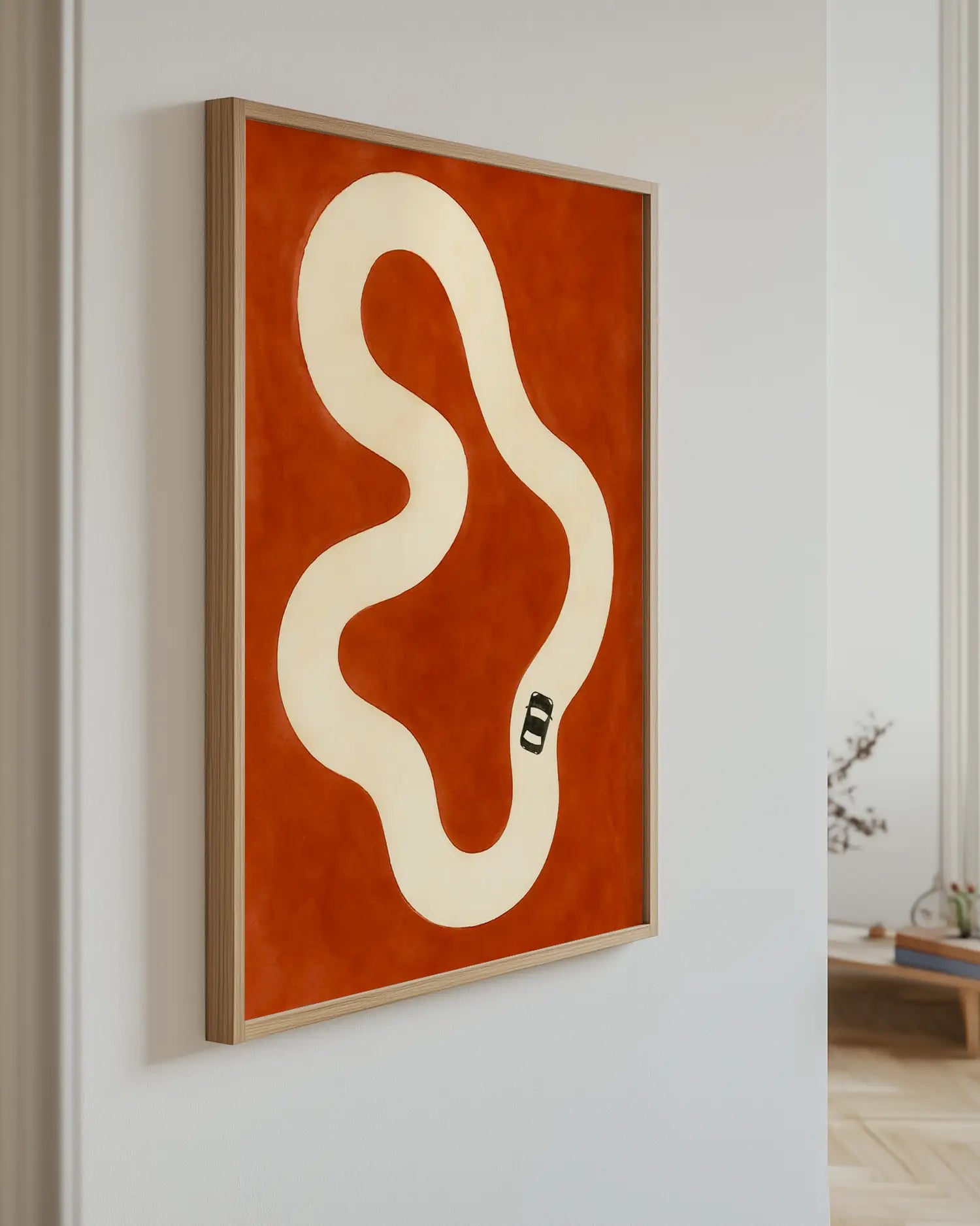 Wallart with a car track on a red background mounted on the wall.