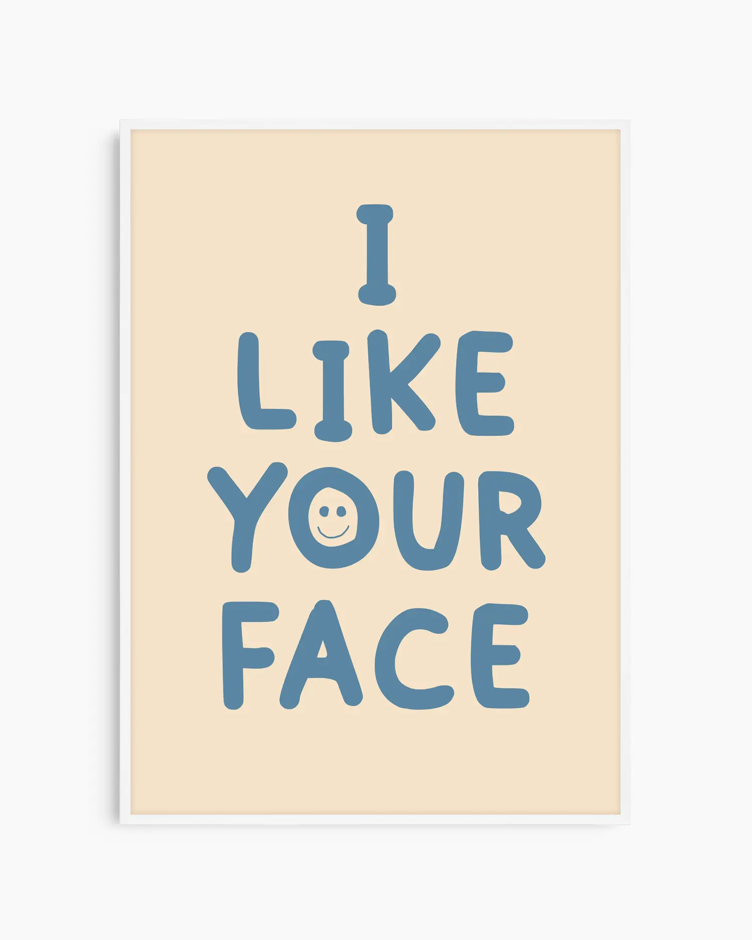 Beige nursery poster with the text 'I like your face' written in blue, framed in a white frame.