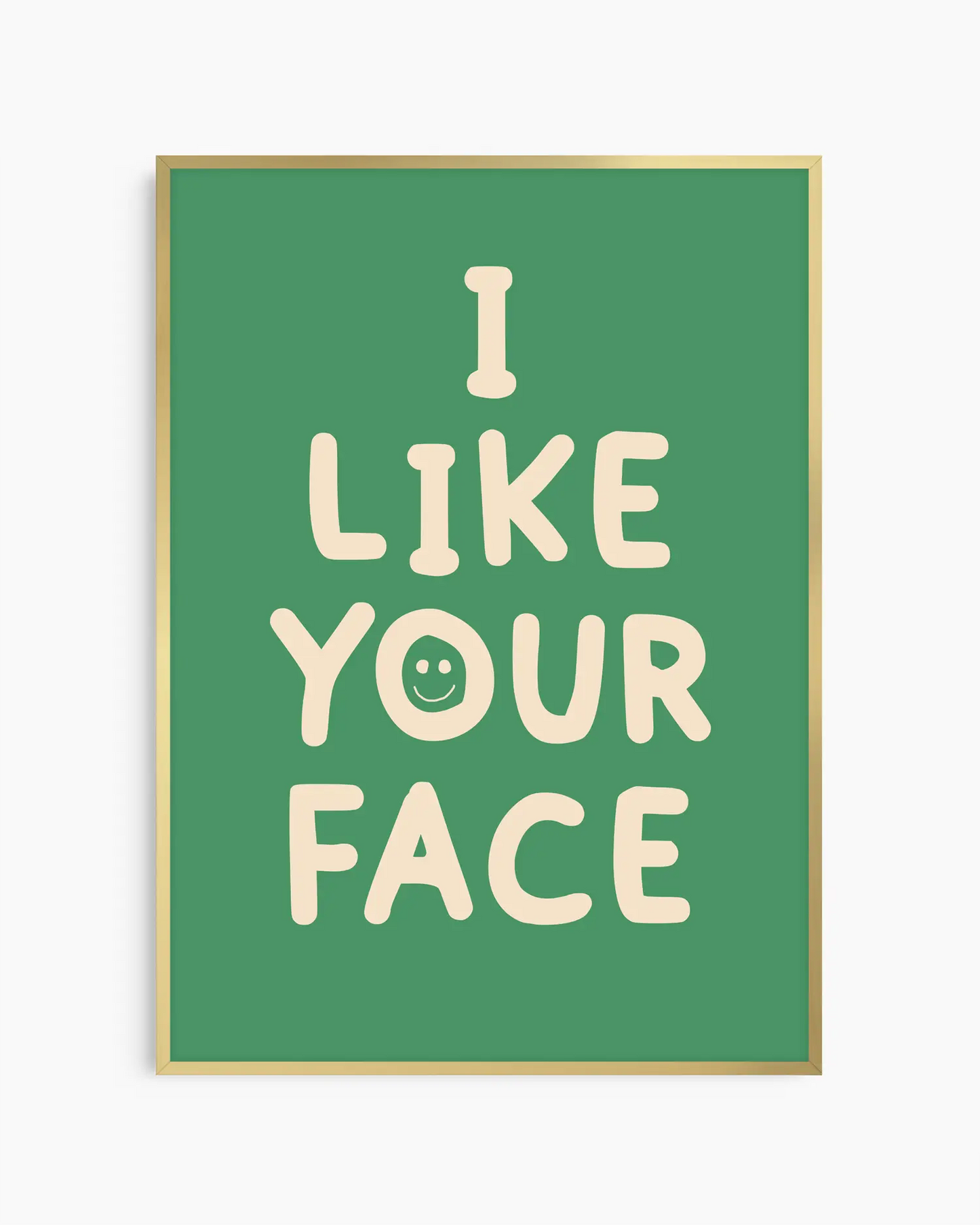 Green nursery poster with the text 'I like your face' written in beige, framed in a gold frame.