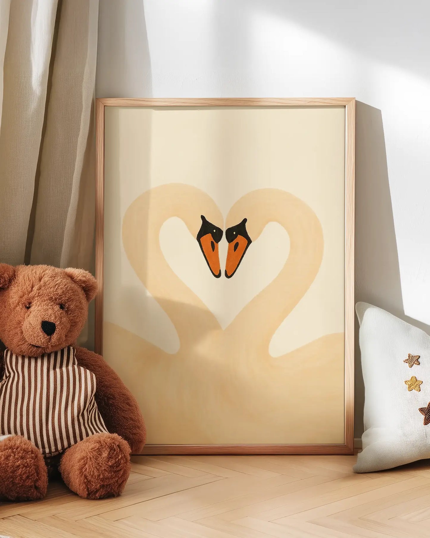 Artwork of two swans forming a heart with a teddy bear and pillow in the foreground.