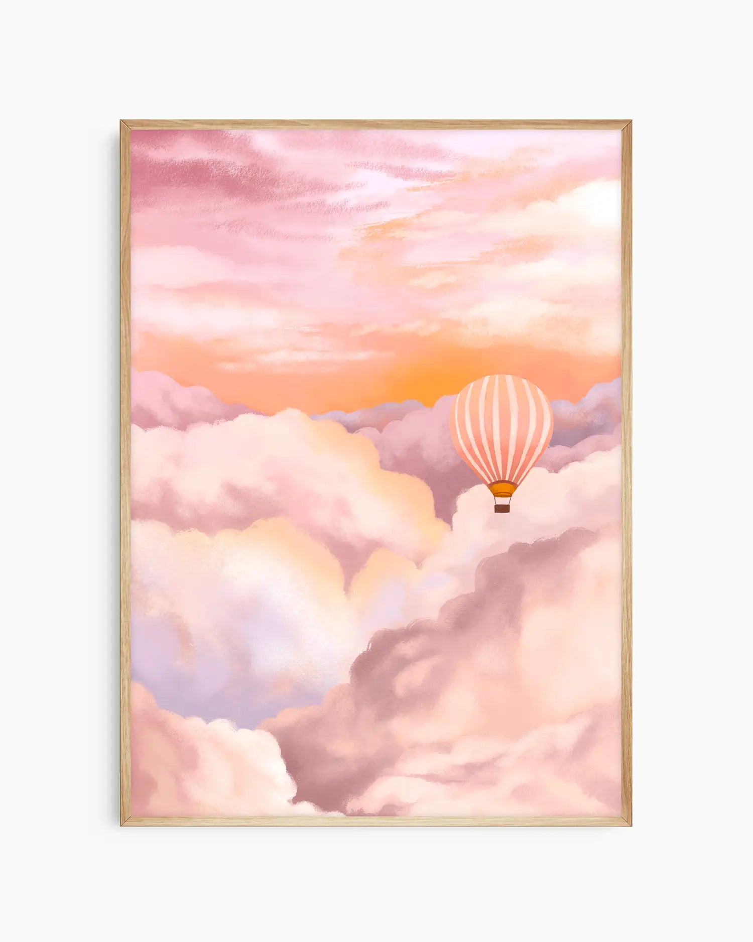 Framed artwork of a hot air balloon in a pink and orange sky with clouds.