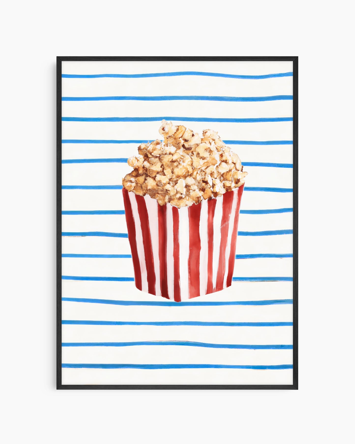 Popcorn in a red and white striped bucket on a blue and white striped background
