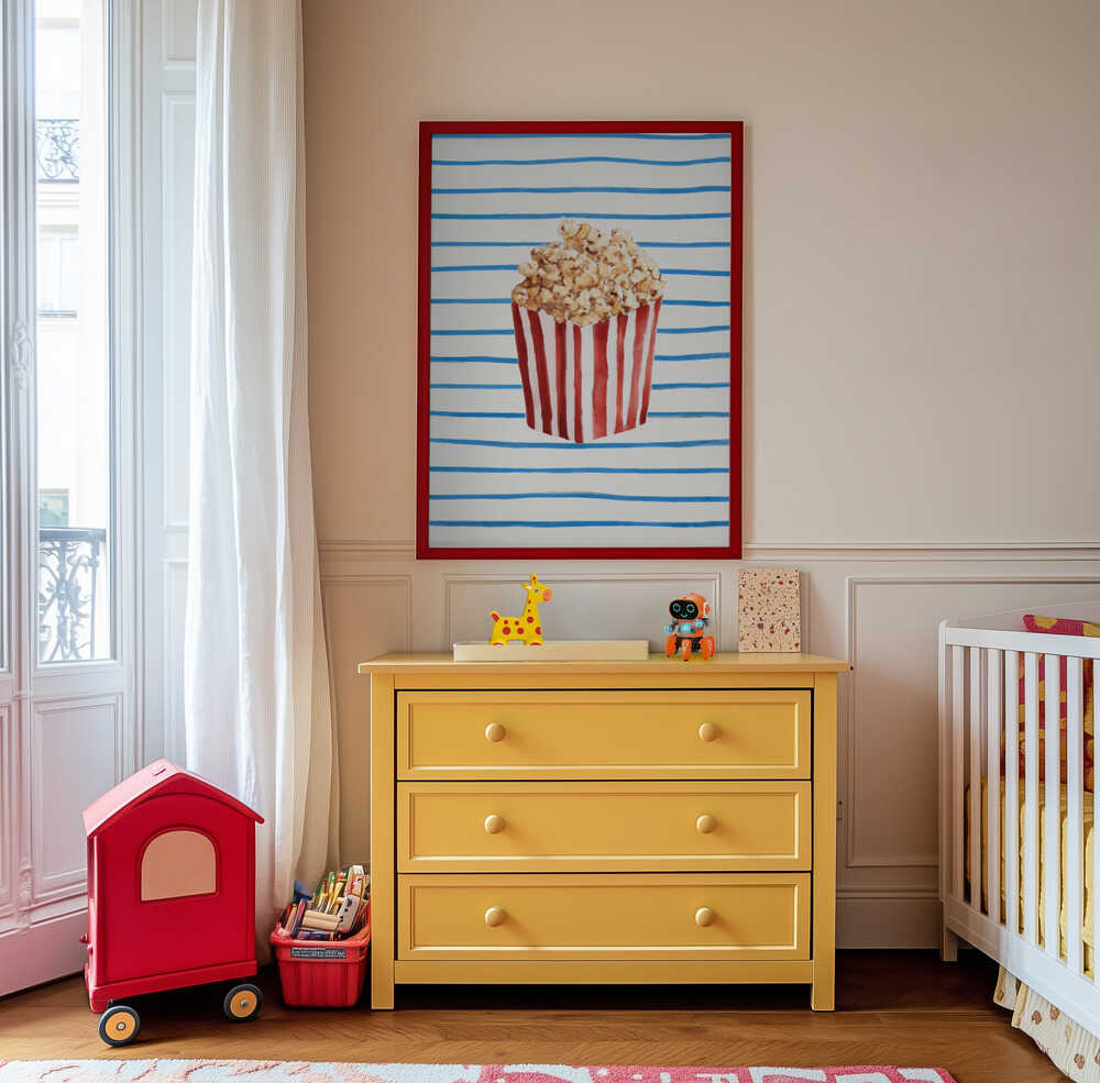 Colorful popcorn art print hanging above a yellow dresser in a playful kids’ room. Featuring a red and white popcorn box with blue stripes, it adds a cheerful and imaginative vibe to modern children’s decor.