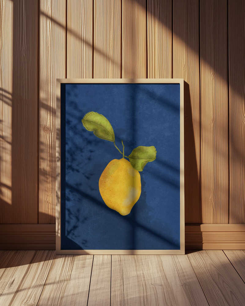 Framed lemon art print leaning against a wood-paneled wall with natural sunlight and shadows. Textured dark blue background and watercolor-style citrus illustration, perfect for modern kitchen decor or Mediterranean-inspired wall art.