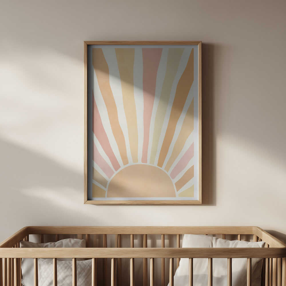Soft pastel sunrise poster framed in light wood and hanging above a baby’s crib. A soothing and stylish wall art piece that creates a warm, peaceful atmosphere in a modern nursery.